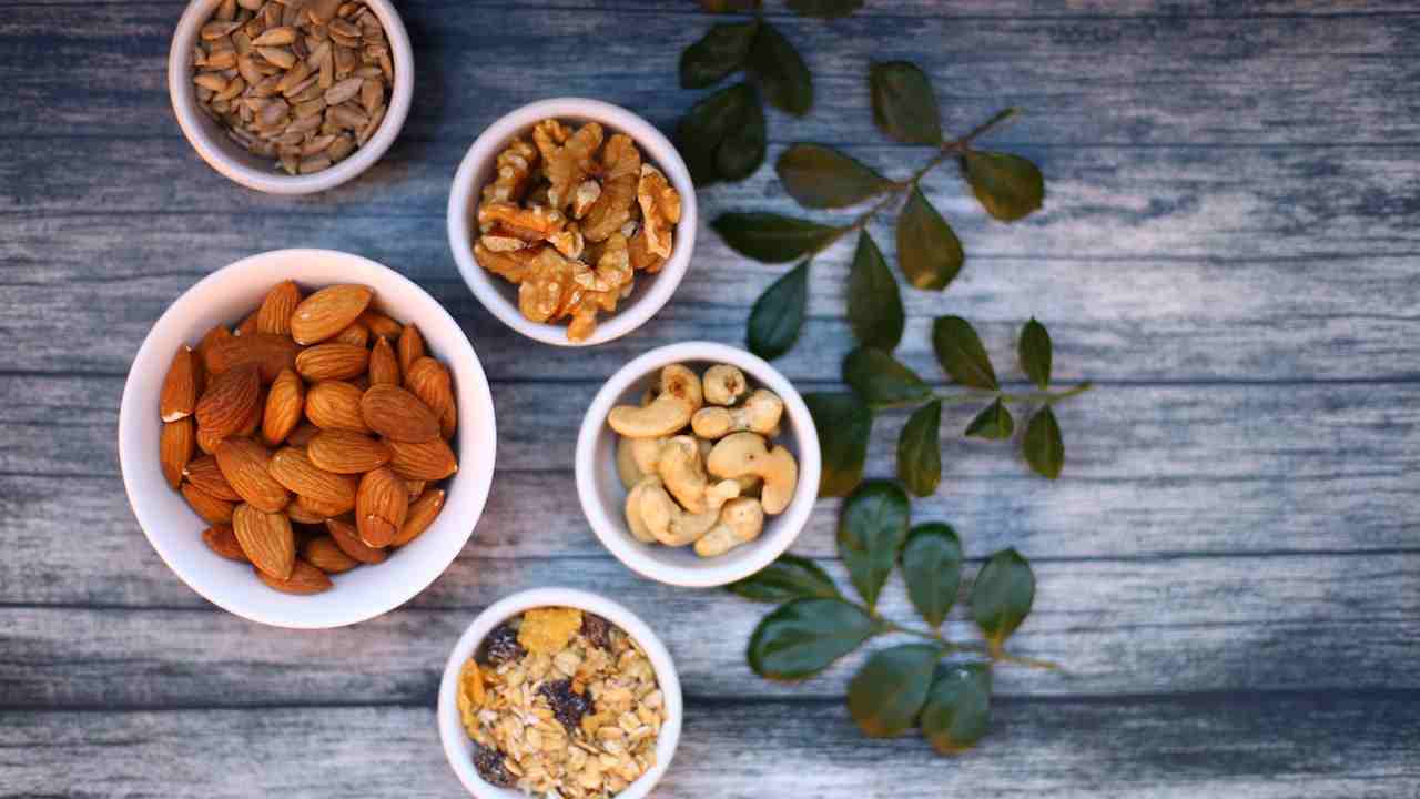 Cinque ciotole contenenti diversi tipi di frutta secca