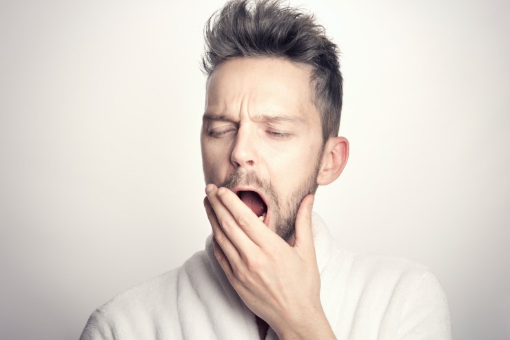 Uomo sbadiglia a causa del jet lag